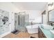 Modern bathroom with a soaking tub, glass shower, and custom vanity at 1830 Citrus Orchard Way, Valrico, FL 33594