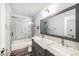 Bathroom featuring double sinks, a large mirror, and a shower over the bath at 1830 Citrus Orchard Way, Valrico, FL 33594