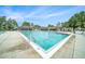 Rectangular community pool with lounge chairs, shaded seating and plenty of space to swim and relax at 1830 Citrus Orchard Way, Valrico, FL 33594