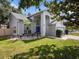 Attractive home with a blue front door, lush green lawn, and well-kept landscaping at 1830 Citrus Orchard Way, Valrico, FL 33594