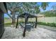 Cozy gazebo with comfortable seating on a paved patio, perfect for outdoor relaxation at 1830 Citrus Orchard Way, Valrico, FL 33594