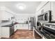 Modern kitchen with white cabinets, stainless steel appliances, and granite countertops at 1830 Citrus Orchard Way, Valrico, FL 33594