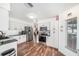 Well-lit kitchen with stainless steel appliances, granite countertops, and white cabinets at 1830 Citrus Orchard Way, Valrico, FL 33594