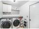 Bright laundry room featuring modern washer and dryer and storage at 1830 Citrus Orchard Way, Valrico, FL 33594