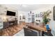 Open-concept living room with fireplace, wood floors, and dining area at 1830 Citrus Orchard Way, Valrico, FL 33594