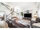 Bright living room featuring high ceilings, wood floors, comfortable leather seating and staircase at 1830 Citrus Orchard Way, Valrico, FL 33594