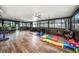 Spacious recreation room with hardwood floors, home gym, comfortable seating, and natural light at 1830 Citrus Orchard Way, Valrico, FL 33594