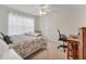 Comfortable bedroom with a ceiling fan, carpet floors, and a dedicated desk area at 1909 E View Dr, Sun City Center, FL 33573