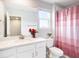 Bright bathroom showcasing a vanity, toilet and decorative shower curtain at 19153 Elsimont Isle, Lutz, FL 33558