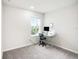 Bright bedroom with carpet and a window provides natural light to work at the desk at 19153 Elsimont Isle, Lutz, FL 33558