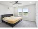 Bright bedroom featuring a queen bed, ceiling fan, and natural light from double windows at 19153 Elsimont Isle, Lutz, FL 33558