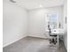 Bright bedroom with carpet and a window provides natural light to work at the desk at 19153 Elsimont Isle, Lutz, FL 33558