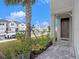 Stylish townhome entrance with a paved walkway, lush landscaping, and a charming front door at 19153 Elsimont Isle, Lutz, FL 33558