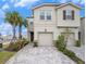 Inviting two-story home with a two-car garage, paved driveway, and well-manicured landscaping at 19153 Elsimont Isle, Lutz, FL 33558