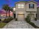 Inviting two-story home with a two-car garage, paved driveway, and well-manicured landscaping at 19153 Elsimont Isle, Lutz, FL 33558