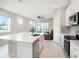 Modern, open-concept kitchen featuring a large island, stainless appliances, and plenty of natural light at 19153 Elsimont Isle, Lutz, FL 33558