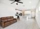 Bright, open-concept living space with a modern ceiling fan, recessed lighting, and hardwood floors at 19153 Elsimont Isle, Lutz, FL 33558