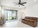 Bright living room featuring a sliding glass door to the backyard and modern finishes at 19153 Elsimont Isle, Lutz, FL 33558