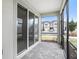 Relaxing screened patio featuring neutral pavers with views of townhome and parking at 19153 Elsimont Isle, Lutz, FL 33558