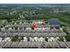 A top-down aerial view showcases the property nestled among neighboring homes and lush green spaces at 19337 Weymouth Dr, Land O Lakes, FL 34638