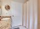Bathroom with a white door and shower with cream colored curtain at 19337 Weymouth Dr, Land O Lakes, FL 34638