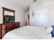 Comfortable bedroom featuring a dark wood dresser and TV at 19337 Weymouth Dr, Land O Lakes, FL 34638