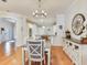 Bright dining area with hardwood floors, a chandelier, and access to the kitchen at 19337 Weymouth Dr, Land O Lakes, FL 34638
