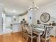 Bright dining area with hardwood floors, modern lighting, and a view of the kitchen at 19337 Weymouth Dr, Land O Lakes, FL 34638