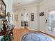 Charming foyer with hardwood floors, decorative rug and a view of the french doors to another room at 19337 Weymouth Dr, Land O Lakes, FL 34638