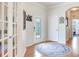 Bright foyer featuring hardwood floors, a decorative rug, and a glass paneled front door at 19337 Weymouth Dr, Land O Lakes, FL 34638
