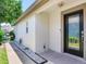Inviting front entrance with a decorative glass door, exterior lighting, and manicured landscaping at 19337 Weymouth Dr, Land O Lakes, FL 34638