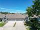 Charming home featuring a two-car garage and well-maintained landscaping beneath a clear, sunny sky at 19337 Weymouth Dr, Land O Lakes, FL 34638