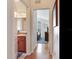 Hallway showing entry to bathroom and bedroom with wood floors at 19337 Weymouth Dr, Land O Lakes, FL 34638
