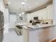 Updated kitchen with white cabinets, granite countertops, tile backsplash, and stainless appliances at 19337 Weymouth Dr, Land O Lakes, FL 34638