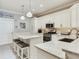 Bright kitchen with white cabinets, granite countertops, stainless steel appliances, and an island with seating at 19337 Weymouth Dr, Land O Lakes, FL 34638