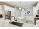 Updated kitchen features white cabinetry, stainless steel appliances, granite countertops, and a kitchen island at 19337 Weymouth Dr, Land O Lakes, FL 34638