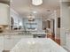 Bright kitchen features quartz countertops, stainless steel appliances, and open layout to the living room at 19337 Weymouth Dr, Land O Lakes, FL 34638