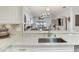 Kitchen features quartz countertops, a stainless steel sink and faucet, and easy access to the living room at 19337 Weymouth Dr, Land O Lakes, FL 34638