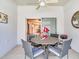 Screened lanai with a ceiling fan, outdoor dining table, and view to the house interior at 19337 Weymouth Dr, Land O Lakes, FL 34638