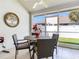 Screened lanai with a ceiling fan, outdoor dining table, and view of the fenced backyard at 19337 Weymouth Dr, Land O Lakes, FL 34638