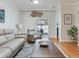 Comfortable living room features hardwood floors and sliding door access to outdoor patio at 19337 Weymouth Dr, Land O Lakes, FL 34638