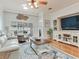 Bright living room features hardwood floors and sliding door access to outdoor patio and large entertainment center at 19337 Weymouth Dr, Land O Lakes, FL 34638