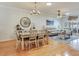 Bright living room with modern furniture, light wood floors, chandelier, and lots of natural light at 19337 Weymouth Dr, Land O Lakes, FL 34638