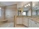 Light-filled bathroom with granite countertops and tiled walk-in shower at 2017 S Pebble Beach Blvd, Sun City Center, FL 33573