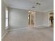 Neutral bedroom showcasing a window with plantation shutters and convenient access to the kitchen and bathroom at 2017 S Pebble Beach Blvd, Sun City Center, FL 33573