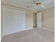 Carpeted bedroom featuring a ceiling fan, closet, and a window with natural light at 2017 S Pebble Beach Blvd, Sun City Center, FL 33573