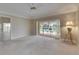 Bright bedroom with sliding glass doors opening to pool and golf course, a ceiling fan, and tan walls at 2017 S Pebble Beach Blvd, Sun City Center, FL 33573