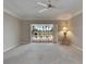 Bright bedroom featuring sliding glass doors opening to the pool and golf course, and a table lamp at 2017 S Pebble Beach Blvd, Sun City Center, FL 33573