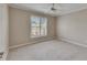 Well-lit bedroom with neutral carpet, fan, and a window with exterior view at 2017 S Pebble Beach Blvd, Sun City Center, FL 33573