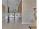 Open foyer with tile flooring leading to a bright living area and pool view at 2017 S Pebble Beach Blvd, Sun City Center, FL 33573